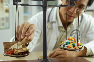 Man Weighing Pills in a Laboratory